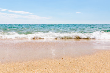 Fototapeta na wymiar Wave on the blue coast of Tyrrhenian sea with sand beach
