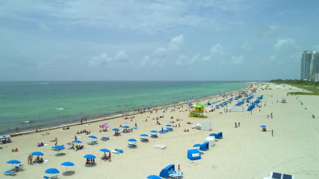 Epic drone shot Miami Beach people on the shore