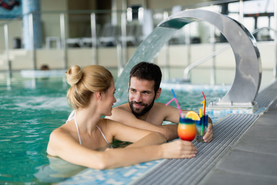 Picture of happy couple relaxing in pool