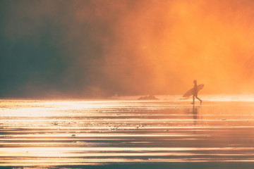 surfer at the sunset with beutiful light