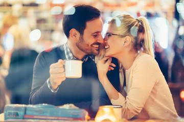 Romantic couple dating in pub at night