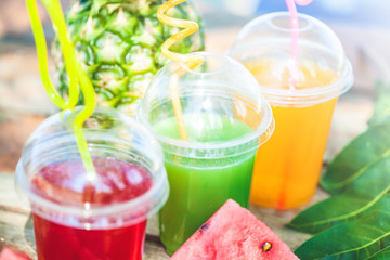 Fresh healthy juices, fruit, pineapple, watermelon on the background of the sea. Summer, rest, healthy lifestyle Close up