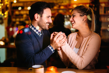 Romantic couple dating in pub at night