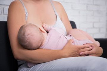 mother breastfeeding her newborn baby girl