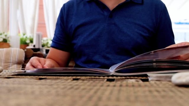 Male Hand Holding Restaurant Menu to Make Order for Lunch