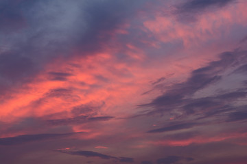 Dramatic fiery sunset sky in a mixture of violet, pink, orange and black colors