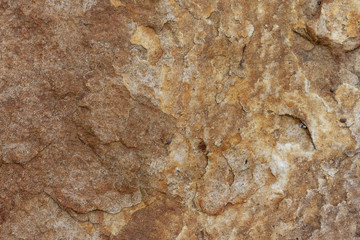 Texture surface stone of mountain gold color for background can use on wall.
