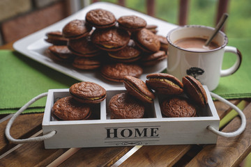 Fudge brownie cookies with penut and cheese filling with cacao on the mug