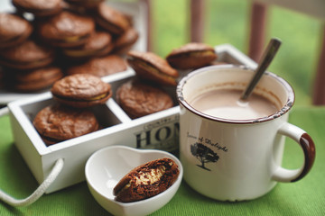 Fudge brownie cookies with penut and cheese filling with cacao on the mug
