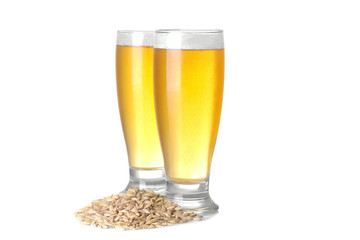 two glasses with a light beer and grains of barley on a white background. isolated