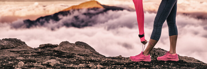 Runner woman getting ready for trail run in volcano altitude mountains background tying up running shoes laces. Fitness and sports motivation healthy lifestyle. Banner panorama.