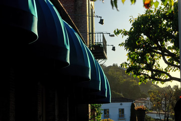 The green awnings outside of a brick building 