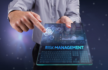 The concept of business, technology, the Internet and the network. A young entrepreneur working on a virtual screen of the future and sees the inscription: Risk management