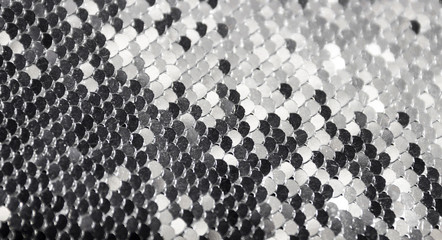 texture background round paillettes of silver color dark and light shine