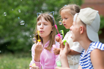 Fototapeta premium children blowing soap bubbles
