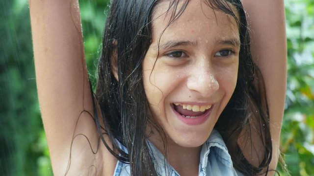 girl with long wet hair is happy with the rain 4k.