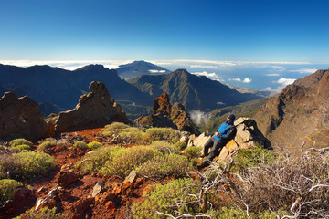 Resting man watching a landscape above the crater Caldera de Taburiente, Island of La Palma, Canary...