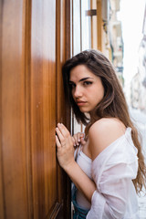 Sensual female standing pressed against door