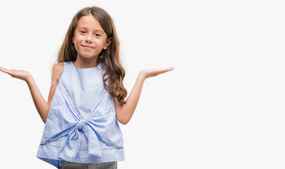 Brunette hispanic girl clueless and confused expression with arms and hands raised. Doubt concept.