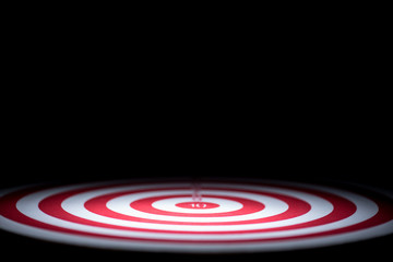 abstract dartboard on dark background lighted with snoot