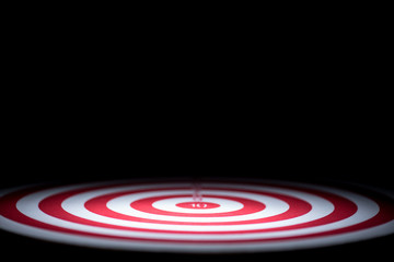Fototapeta premium abstract dartboard on dark background lighted with snoot