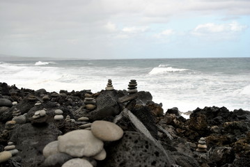 Reunion island seascape, landscape. Black sand, volcanic rocks.