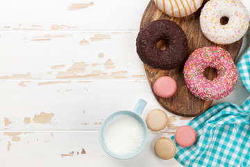 Milk and donuts on wooden table