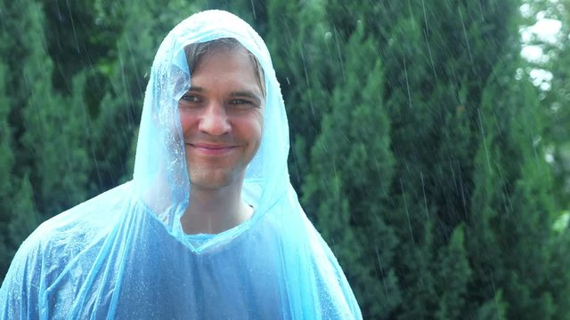 man in raincoat at the rain. 4k, slow motion.