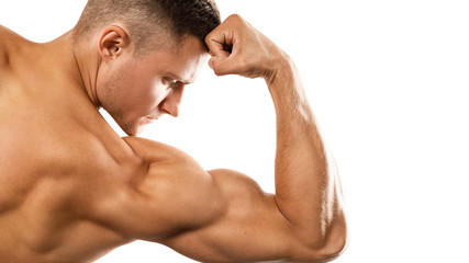 Young muscular man showing his bicep