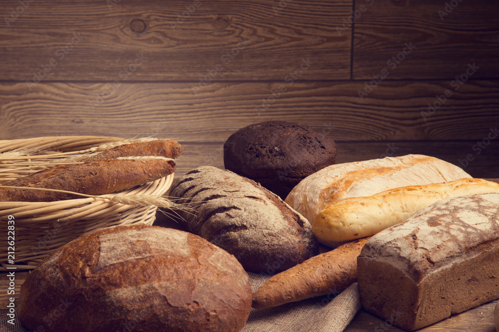 Wall mural bread in stock on a wooden table