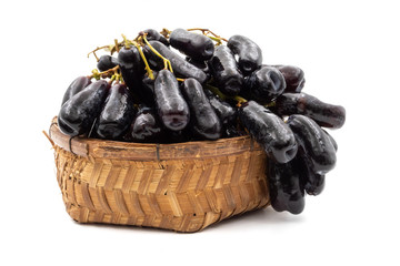 Black seedless moon drops grape or Witch fingers grape in basket on white background