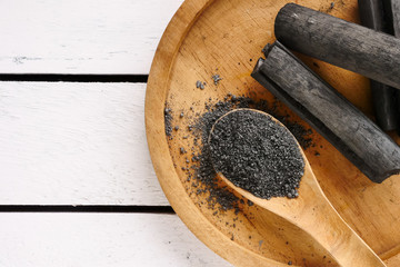 Bamboo charcoal and powder on wooden table. copy space