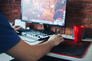 young man playing game on computer
