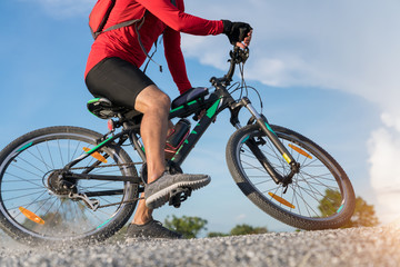 Naklejka premium cyclist man riding a mountain bike up a hill, extreme sport mountain biker