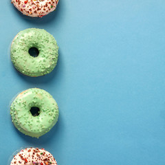 Blue bright background with donuts set in a vertical row