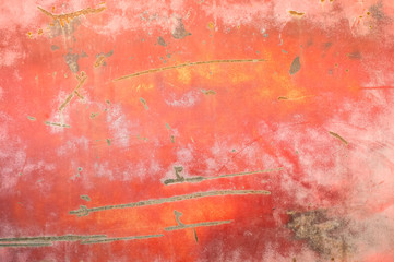 rusting red metal panel with scratches