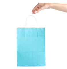 Blue turquoise paper package bag in hand shop shopping fashion on white background isolation