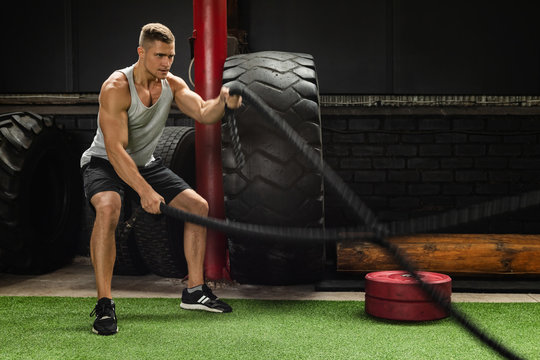 Man Is Making Battle Rope Exercises