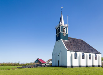Historic village church Zeemanskerk in Oudeschild  on the Wadden island Texel in the Netherlands - obrazy, fototapety, plakaty