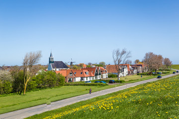 Fototapeta na wymiar Panorama Village Oudeschild with Martinus church, windmill and trraditional gable houses on the Wadden island Texel in the Netherlands