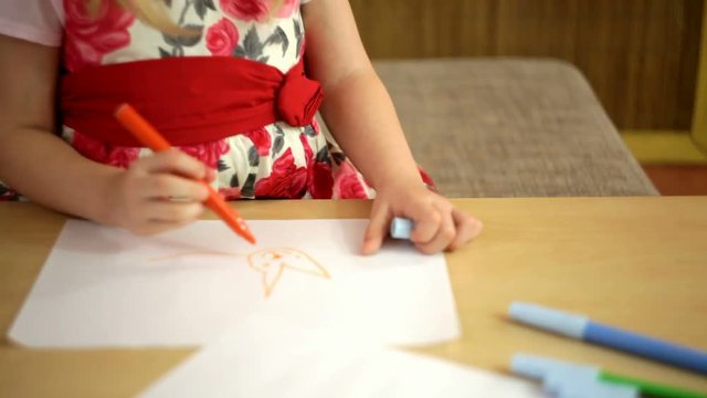 cheerful girl child draws with colored inks