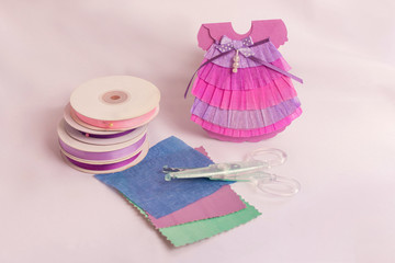 Handmade greeting card. Card to the newborn.The form of the card is a little pink dress.