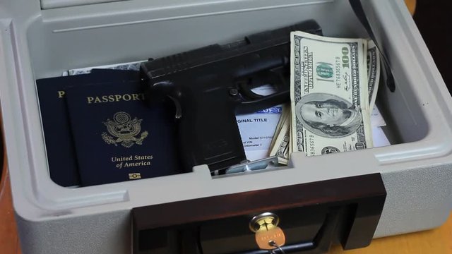 A small safe containing valuables is opened.