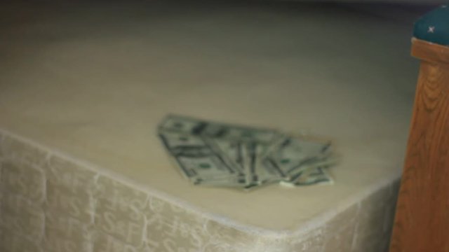 Money is found under the mattress.