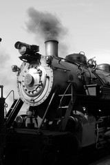 Close up of nose of steam train in black and white