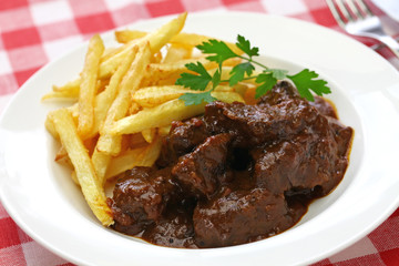 carbonade flamande with frites , flemish beef stew, belgian cuisine