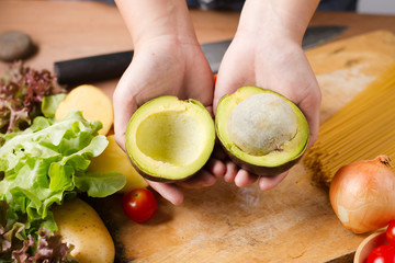 Chef cut avocado prepare for make a vegetable salad. healthy eating and health care, vegetarian,...
