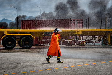 Rescue walk Accident area, Container Truck crash accident on the road in the port and fire burning up. fire flame in an emergency situation. Fireman using water and extinguisher to fighting 