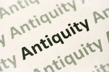 word Antiquity printed on paper macro