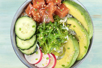 Hawaiian tuna poke salad on teal, closeup photo